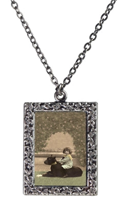 Child with her dog necklace